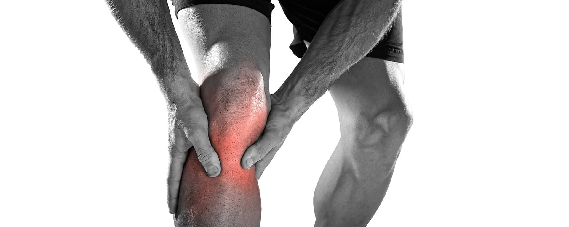 A person holding a painful knee